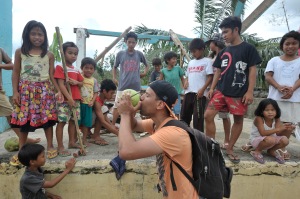 Sharing a drink and a laugh with kids in the village of Liberty. Coconut milk is delicious.